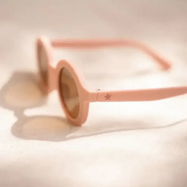 Óculos de sol infantis redondos rosa claro com proteção UV400, perfeitos para dias ensolarados.