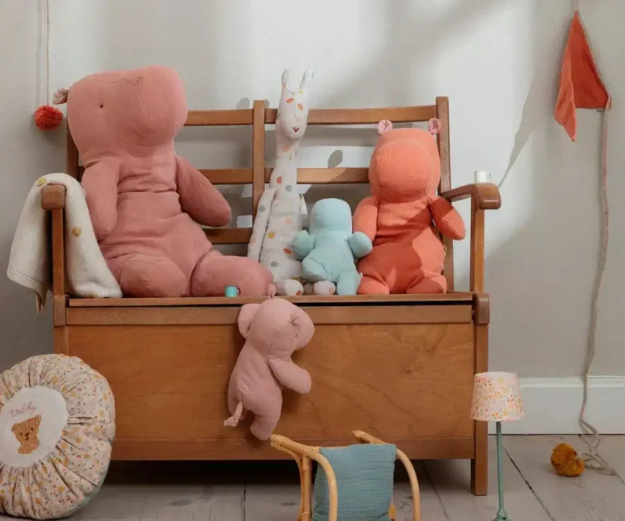 Colorful Maileg plush toys displayed on a wooden bench, perfect for inspiring children's imagination.