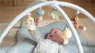 Baby exploring the Little Dutch Forest Friends play gym with plush toys, promoting sensory development and motor skills.