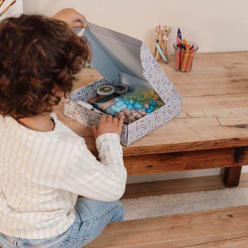 Child exploring the creative XL Forest Friends kit from Little Dutch, showcasing arts and crafts supplies.