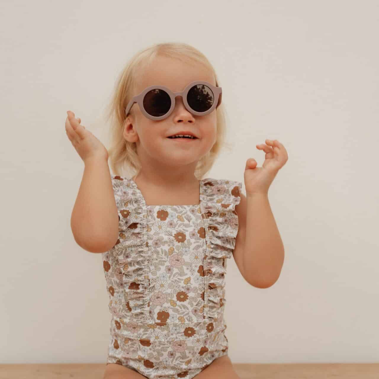 Child wearing Vintage Little Flowers Fato de Banho Folhos by Little Dutch with sunglasses.