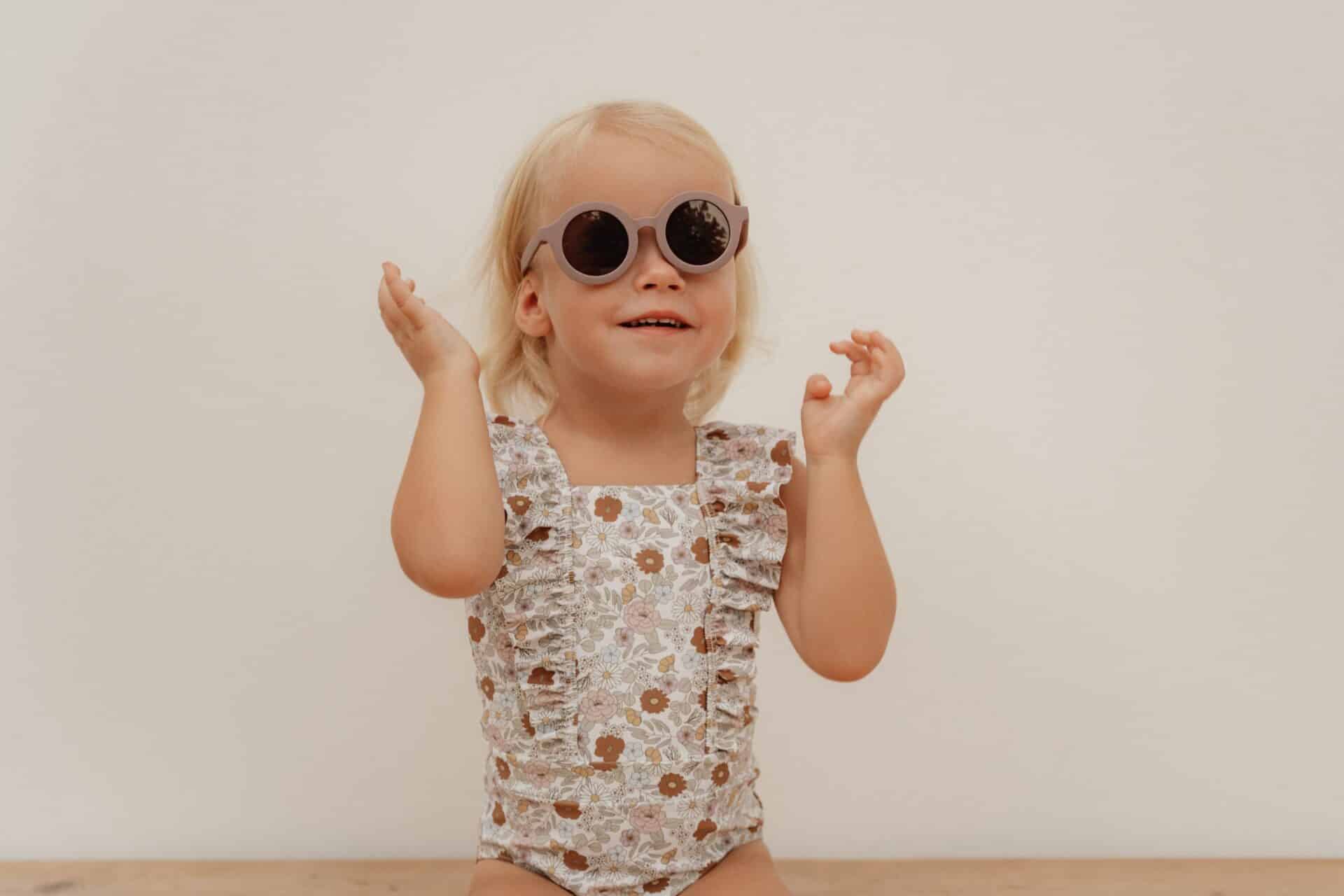 Child wearing Vintage Little Flowers Fato de Banho Folhos by Little Dutch with sunglasses.