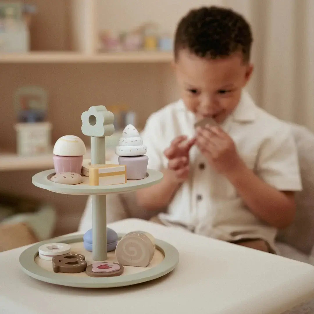 Bandeja de Bolos Little Dutch com doces de madeira em uma mesa, criança brincando com a bandeja de chá.