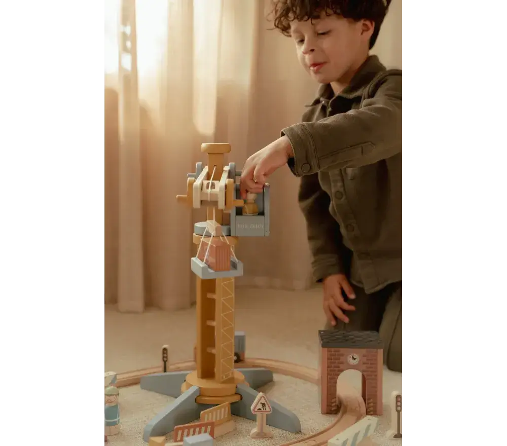 Criança brincando com Pista com Grua de Construção - Little Dutch, movimentando a grua e acessórios.