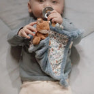 Baby cuddling soft Little Dutch forest-themed doudou with a fox, featuring soothing textures and a pacifier.